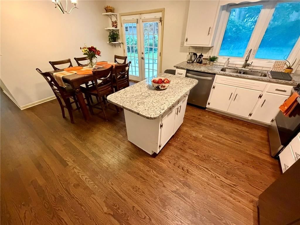 Kitchen island, granite counters and stainless steel appliances at 8842 Foster Lane, Overland Park, KS 66212