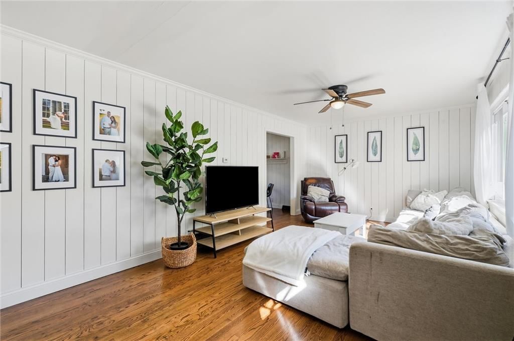Hardwood floors and shiplap / paneling at 3400 E 107th Terrace, Kansas City, MO 64137