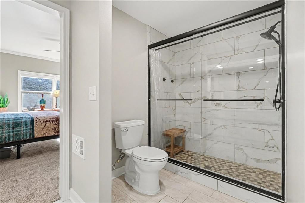 Walk-in shower, tiled shower and frameless glass shower at 12201 Caenen Drive, Overland Park, KS 66213