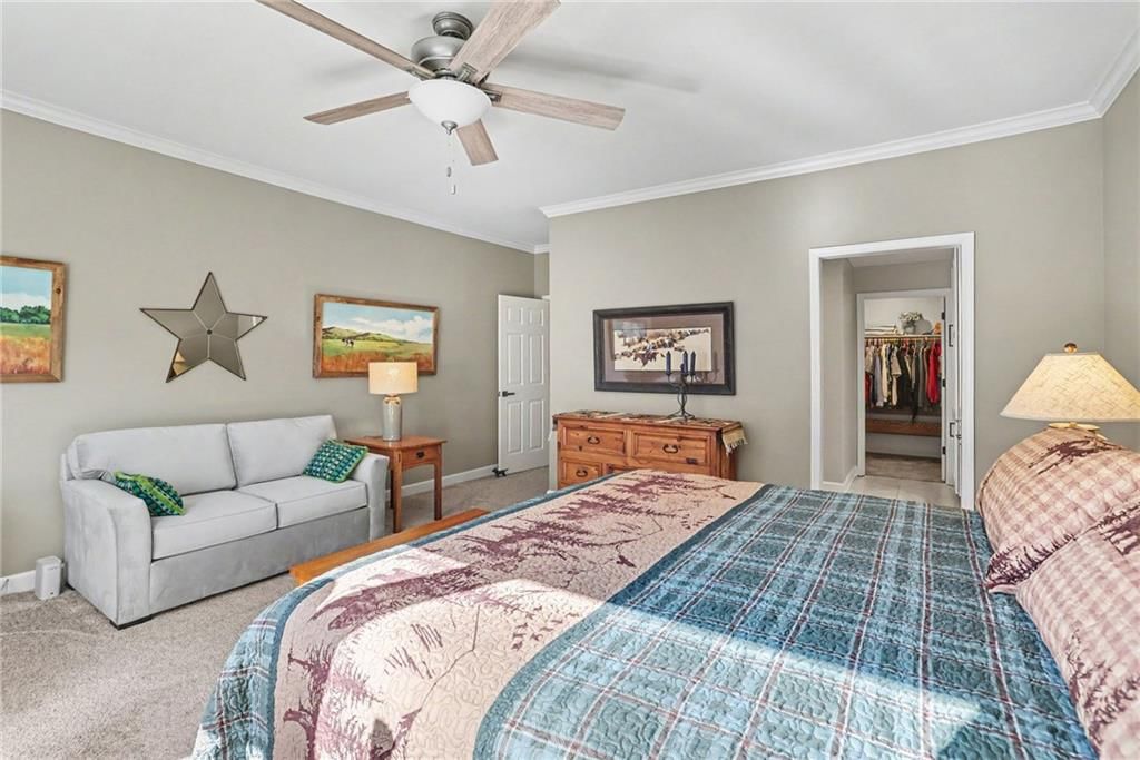 Main-floor primary bedroom and bedroom sitting area at 12201 Caenen Drive, Overland Park, KS 66213