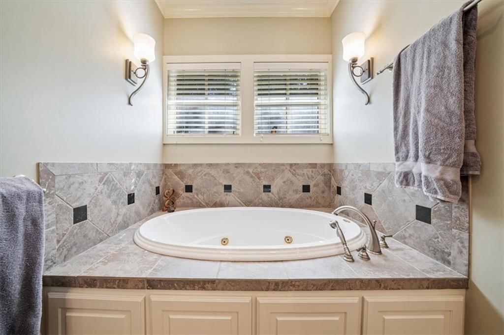 Walk-in shower and tiled shower at 14204 Bluejacket Street, Overland Park, KS 66221