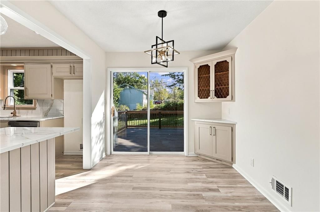 Open floor plan, statement lighting and breakfast nook at 8915 E 57TH Street, Raytown, MO 64133