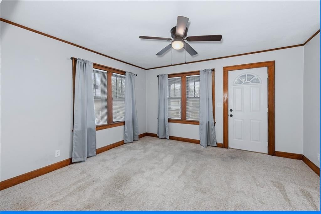 Main-floor primary bedroom and carpet at 124 S Myrtle Street, Excelsior Springs, MO 64024