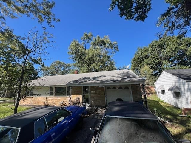 Attached garage and concrete driveway at 2504 Westport Road, Independence, MO 64052