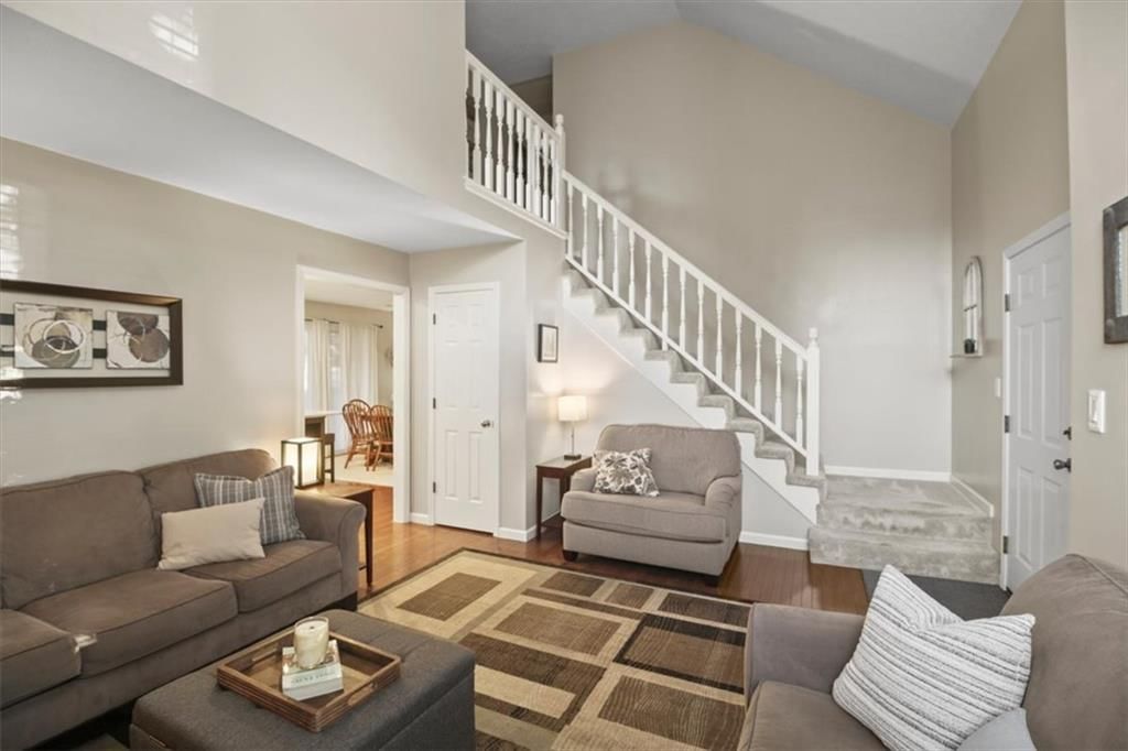 Hardwood floors, staircase and wood stair railing at 2104 NW Hidden Pointe Court, Blue Springs, MO 64015