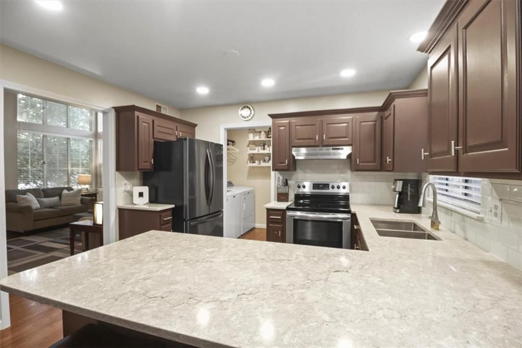 Kitchen island, kitchen backsplash and recessed lighting at 2104 NW Hidden Pointe Court, Blue Springs, MO 64015