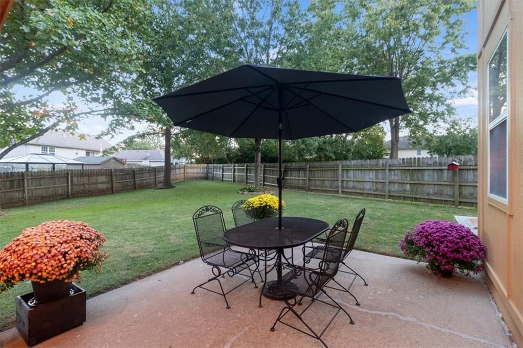 Big backyard, fenced yard and concrete patio at 2104 NW Hidden Pointe Court, Blue Springs, MO 64015
