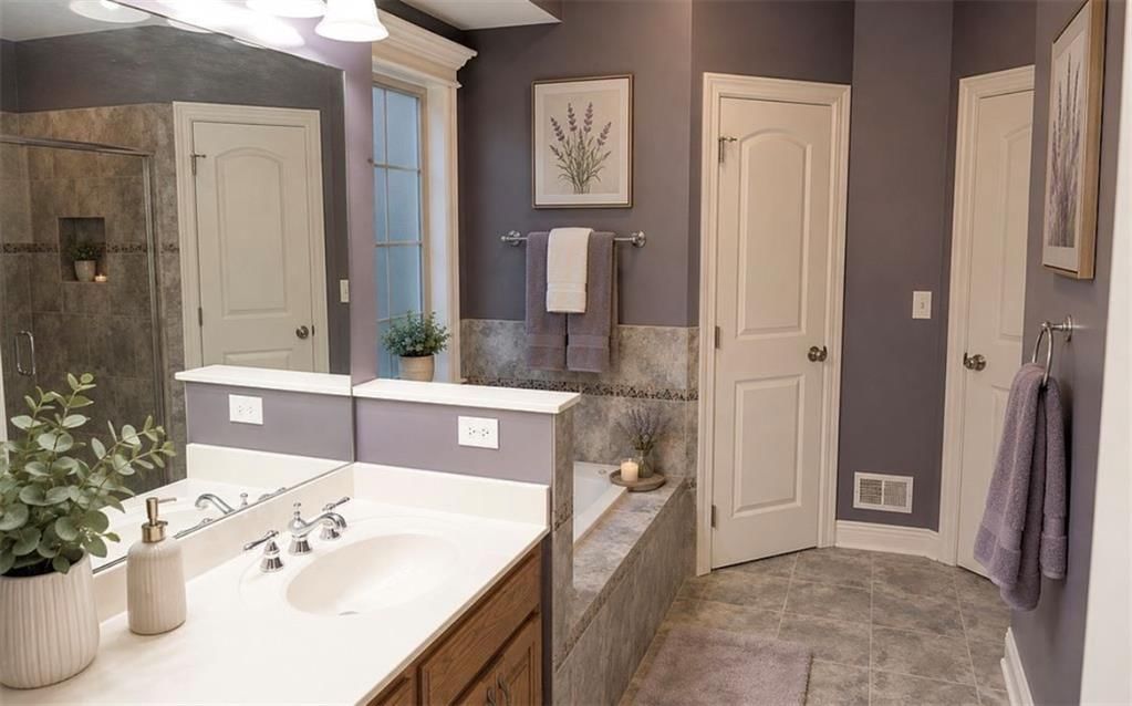 Tiled shower and double vanity at 907 Order No. 11, Freeman, MO 64746
