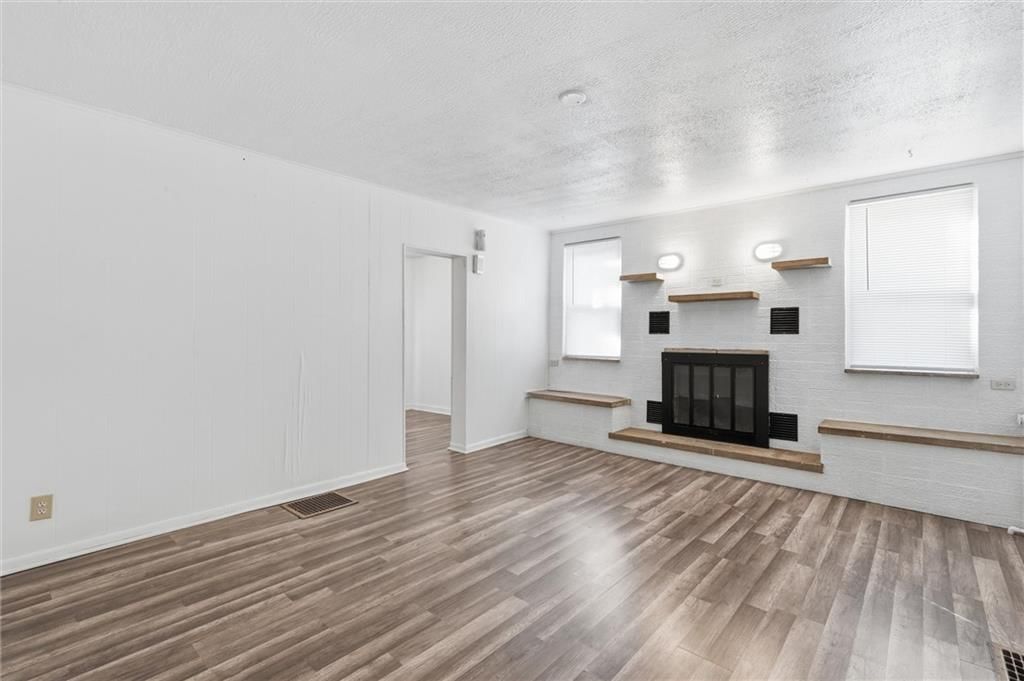 Fireplace, luxury vinyl floors and white trim at 838 Ottawa Street, Leavenworth, KS 66048