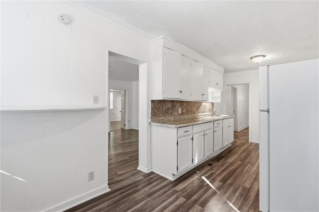 White kitchen, white appliances and kitchen backsplash at 838 Ottawa Street, Leavenworth, KS 66048
