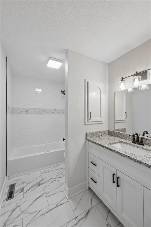 Tiled shower and renovated bathrooms at 139 E 3rd Street, Tonganoxie, KS 66086