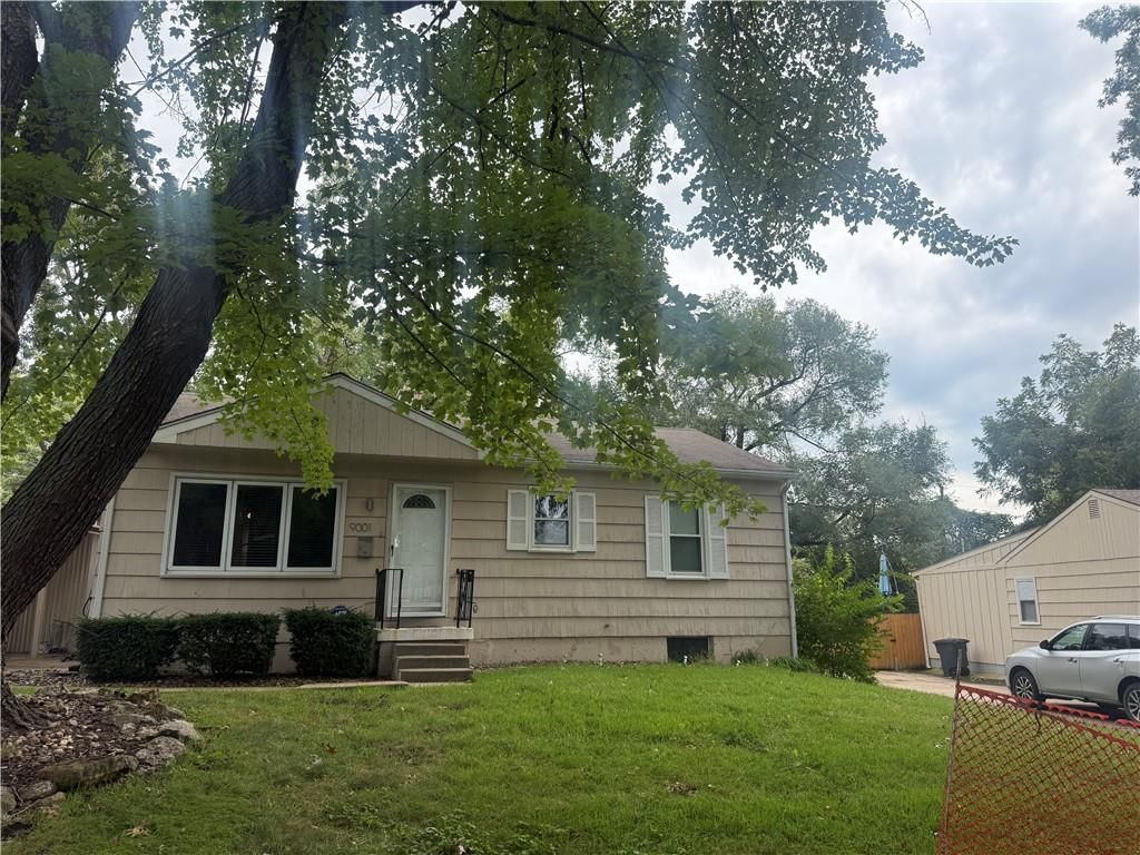 Fenced yard, mature trees and attached garage at 9001 Central Street, Kansas City, MO 64114