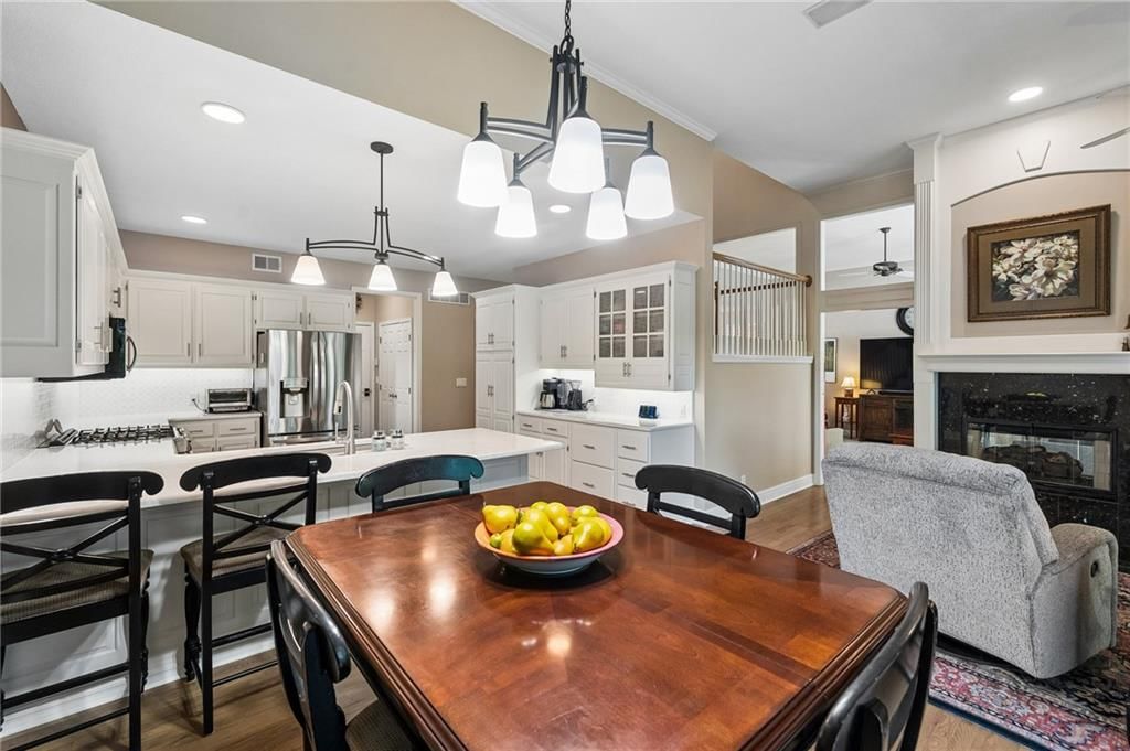 Open floor plan, kitchen island and white kitchen at 20405 W 98th Court, Lenexa, KS 66220