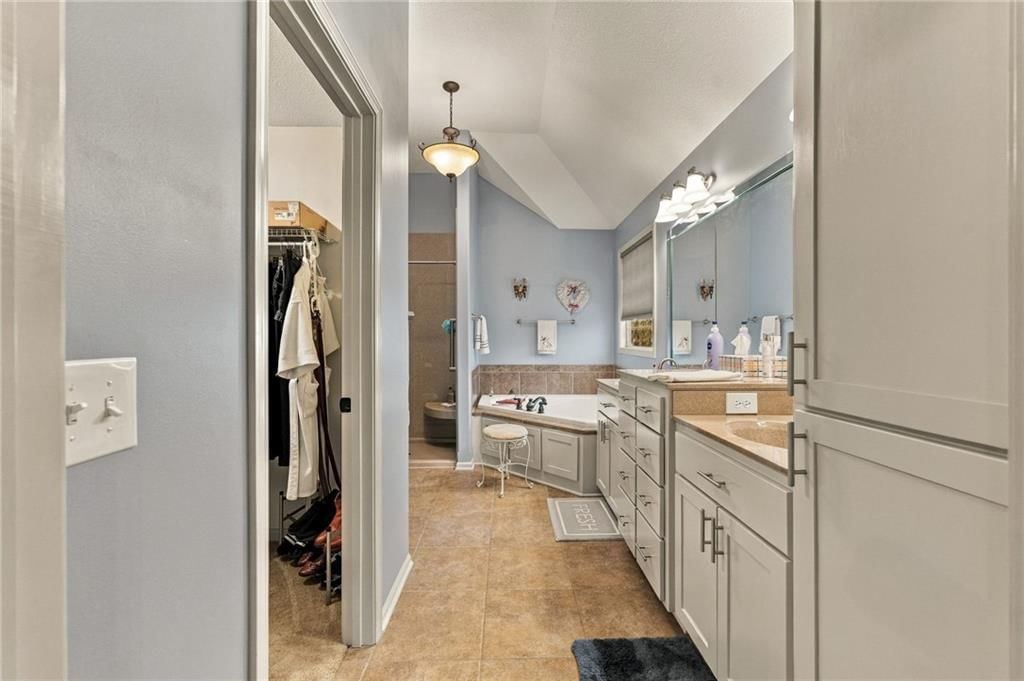 Walk-in shower, tiled shower and double vanity at 343 SE WOOD Lane, Lee's Summit, MO 64063