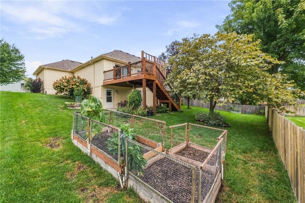Big backyard, fenced yard and covered patio at 343 SE WOOD Lane, Lee's Summit, MO 64063