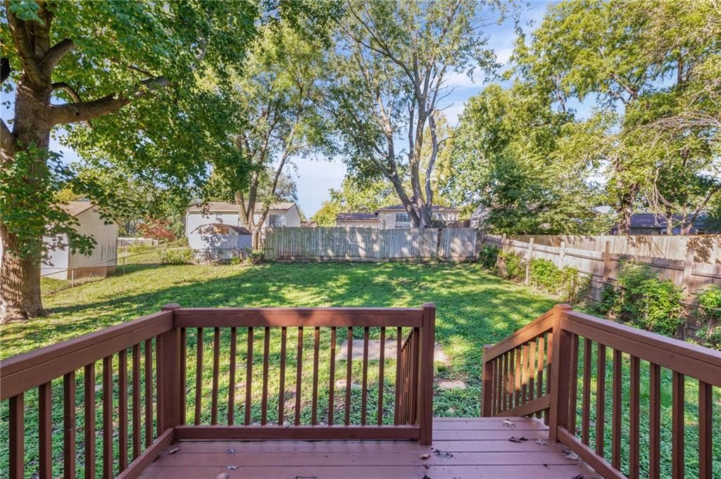 Deck, big backyard and fenced yard at 2200 Aqueduct Place, Independence, MO 64057