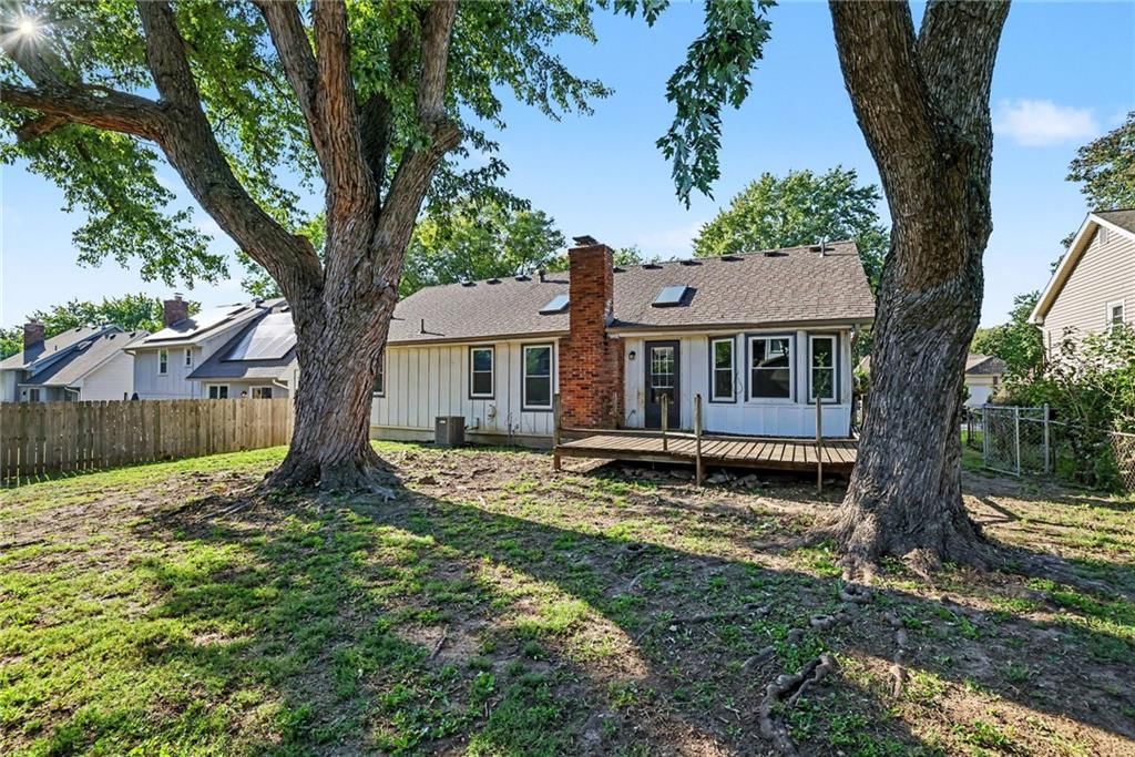 Deck, fenced yard and mature trees at 13935 S Cottonwood Drive, Olathe, KS 66062