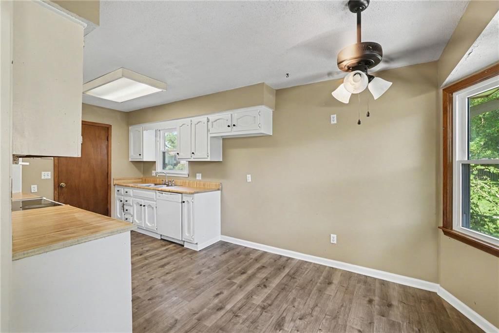 Open floor plan, white kitchen and breakfast nook at 13935 S Cottonwood Drive, Olathe, KS 66062