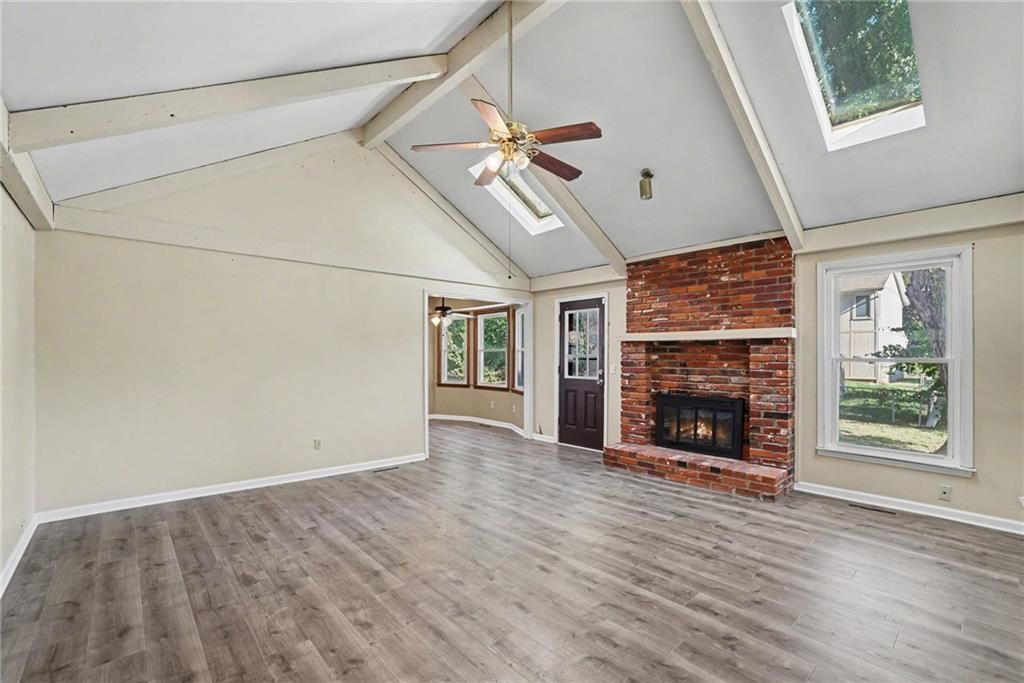 Fireplace, exposed brick wall and ceiling beams at 13935 S Cottonwood Drive, Olathe, KS 66062