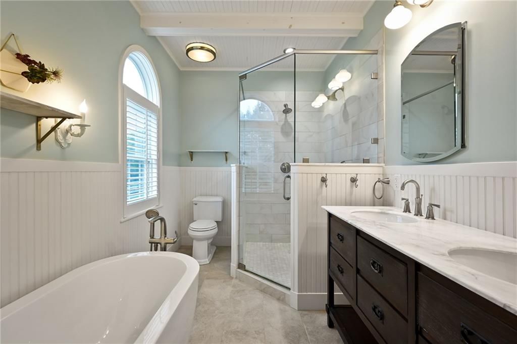 Wainscoting or board and batten, walk-in shower and freestanding tub at 3955 W 214th Street, Bucyrus, KS 66013