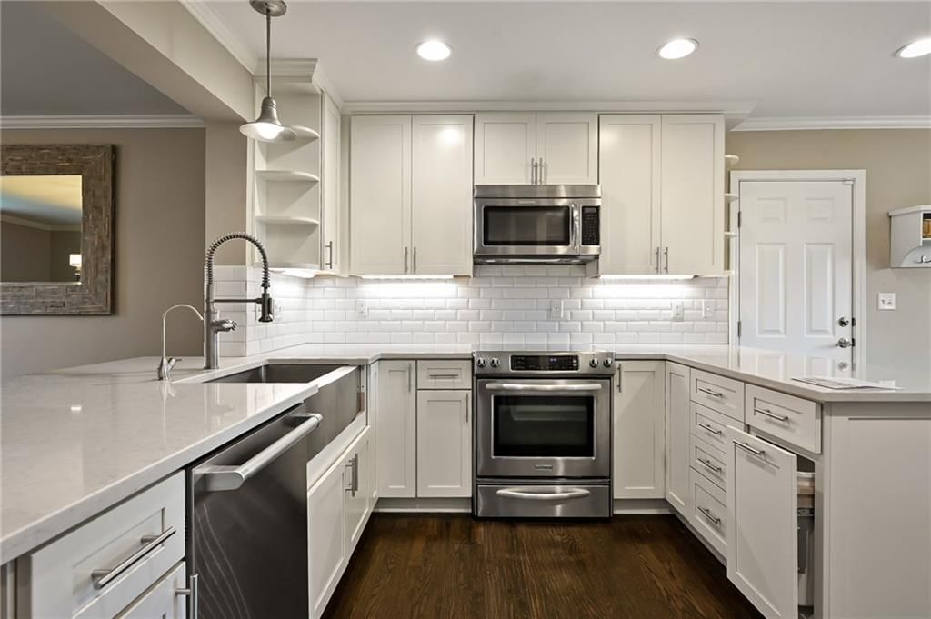 Kitchen island, white kitchen and quartz counters at 3955 W 214th Street, Bucyrus, KS 66013