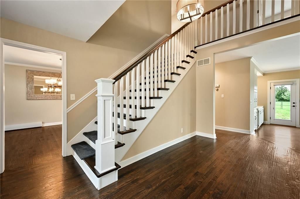 Hardwood floors, staircase and wood stair railing at 3955 W 214th Street, Bucyrus, KS 66013