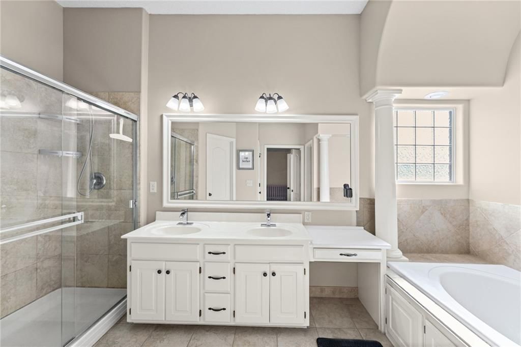 Tile floors, walk-in shower and tiled shower at 1113 Creekside Court, Raymore, MO 64083