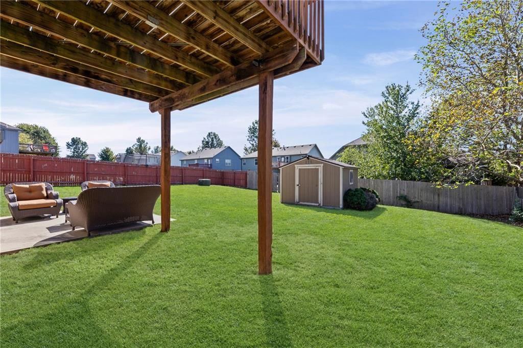 Big backyard, fenced yard and wood fence at 1113 Creekside Court, Raymore, MO 64083
