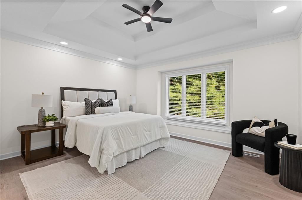 Main-floor primary bedroom and tray ceiling at 510 NW Ashurst Place, Lee's Summit, MO 64081