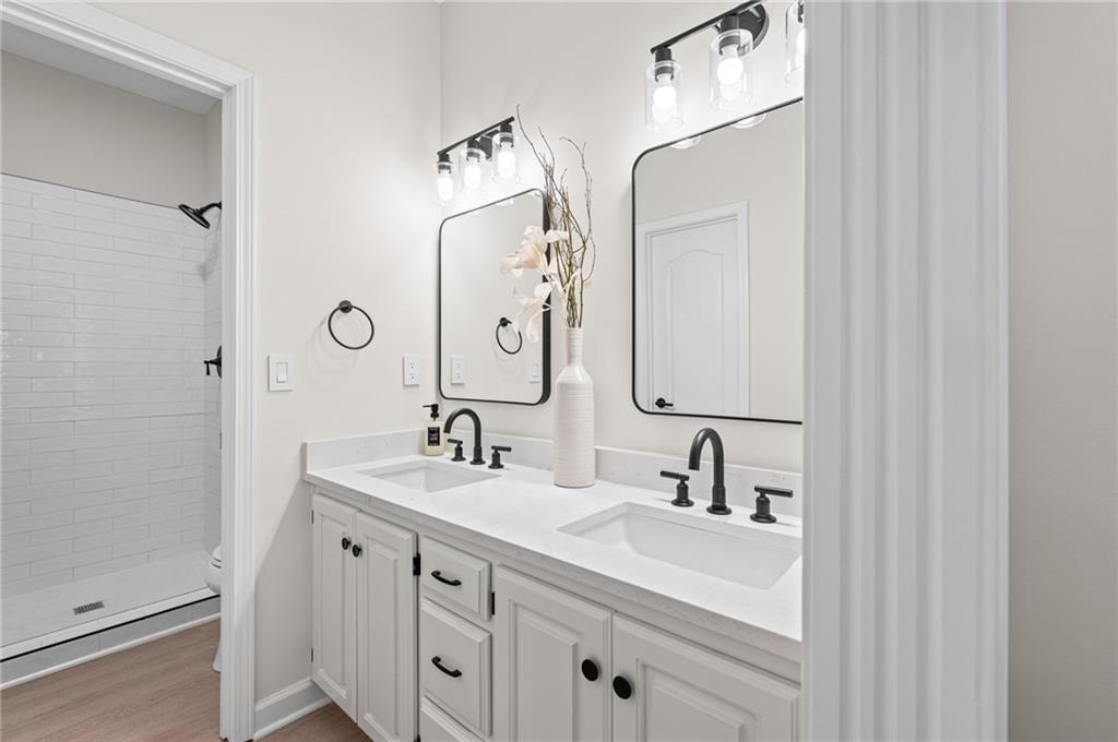 Double vanity, white vanity and renovated bathrooms at 510 NW Ashurst Place, Lee's Summit, MO 64081