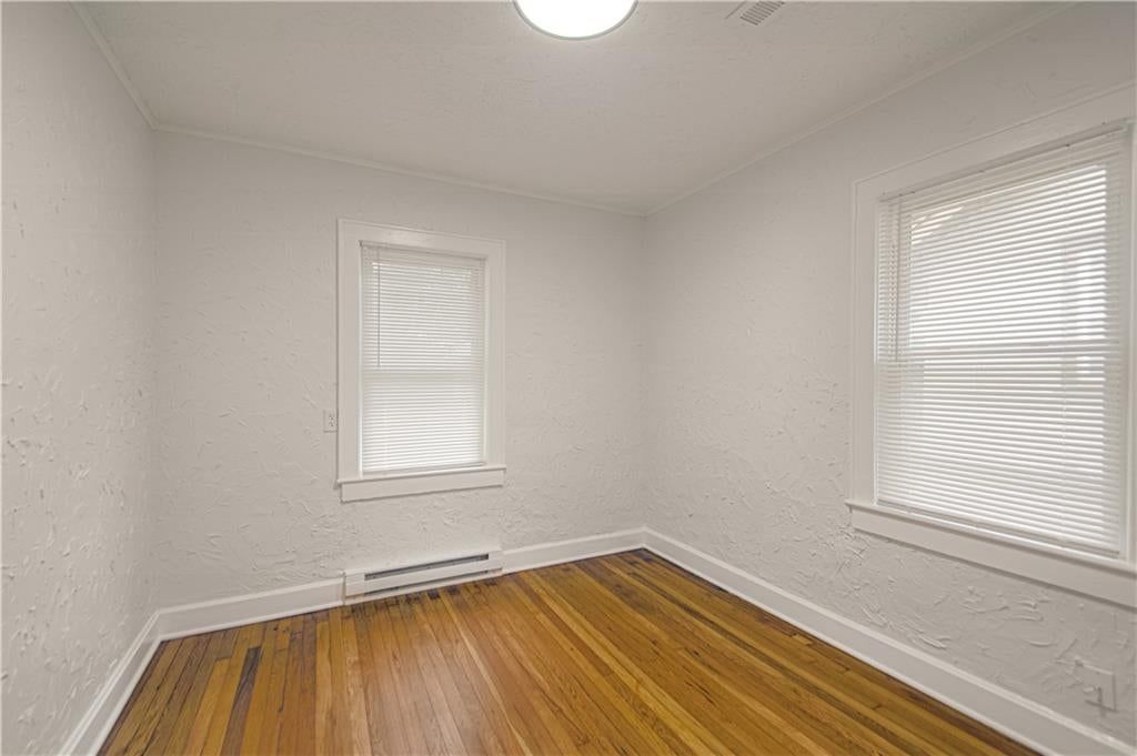 Main-floor primary bedroom at 7730 Jefferson Street, Kansas City, MO 64114