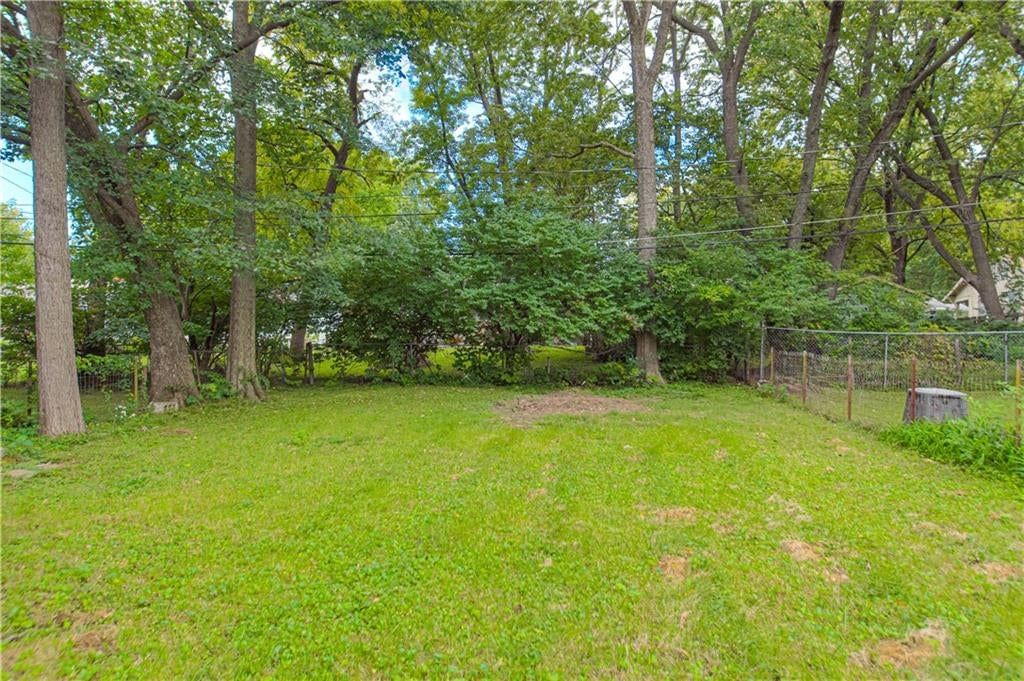 Fenced yard and mature trees at 7730 Jefferson Street, Kansas City, MO 64114
