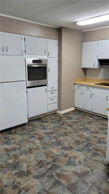 White kitchen cabinets and white appliances at 4801 NW 61st Street, Kansas City, MO 64151