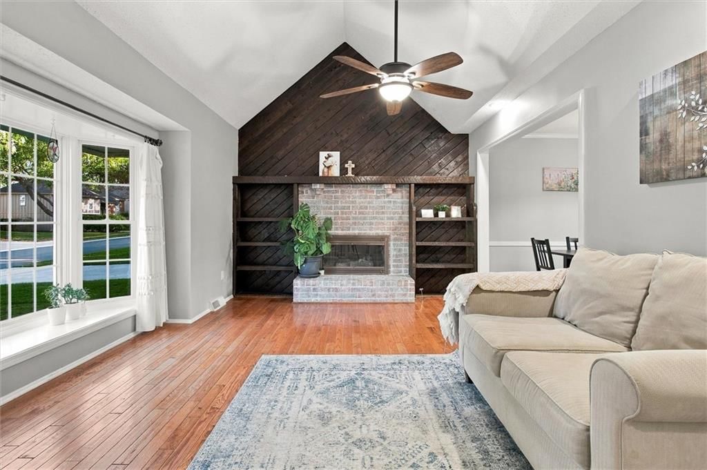 Fireplace, white trim and gray walls at 13929 S Summertree Lane, Olathe, KS 66062