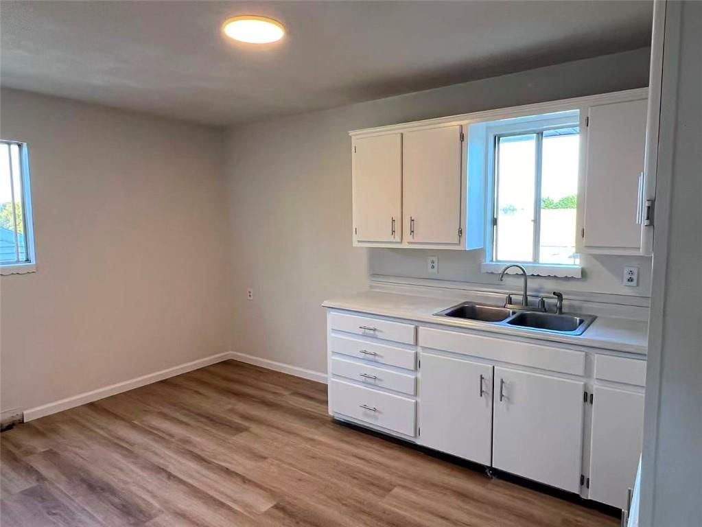 White kitchen and breakfast nook at 5013/5015 N Bellaire Avenue, Kansas City, MO 64119