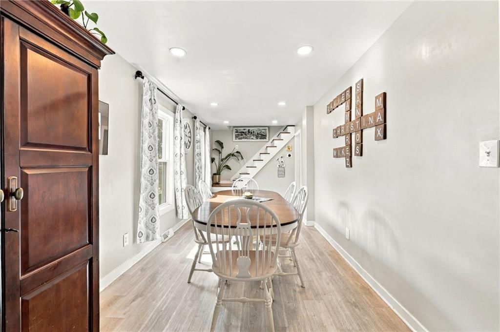 Luxury vinyl floors, recessed lighting and staircase at 2638 Jarboe Street, Kansas City, MO 64108