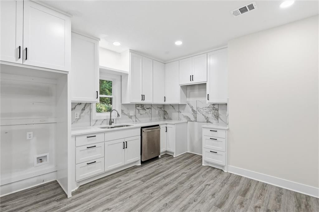 White kitchen, shaker cabinets and stainless steel appliances at 614 Spruce Street, Leavenworth, KS 66048