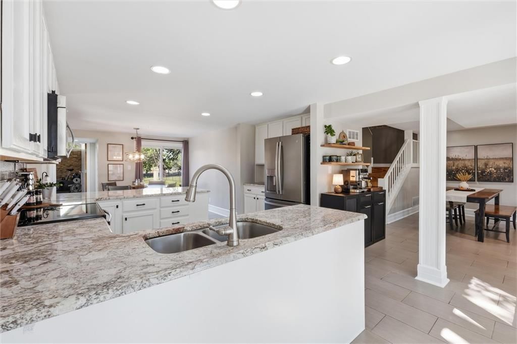 Kitchen island and granite counters at 14340 S Gardner Road, Gardner, KS 66030