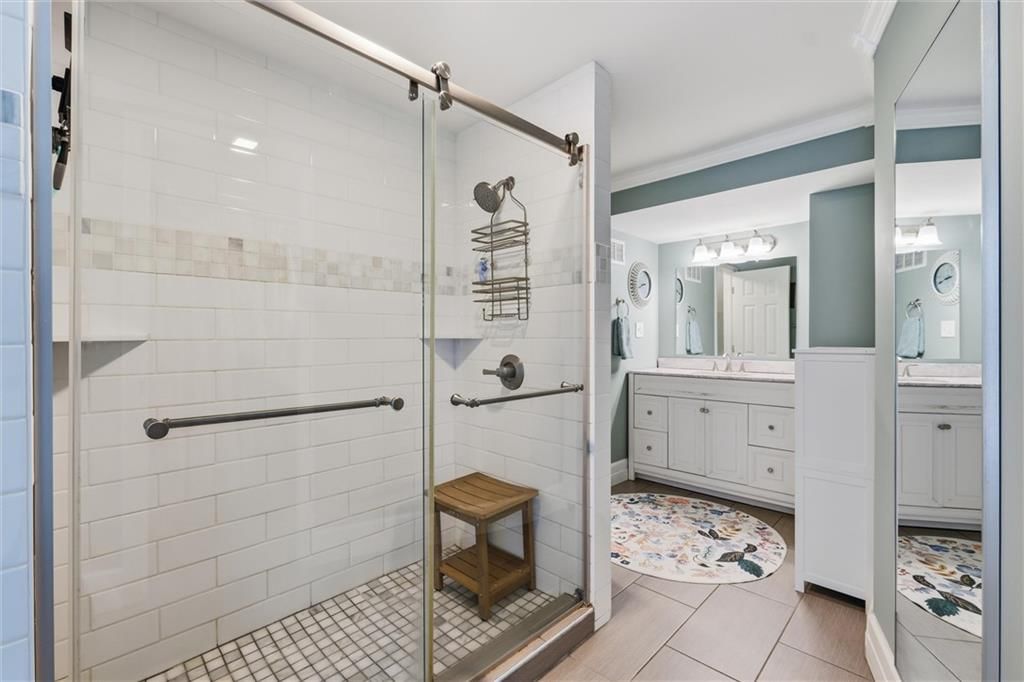 Walk-in shower, tiled shower and double vanity at 14340 S Gardner Road, Gardner, KS 66030
