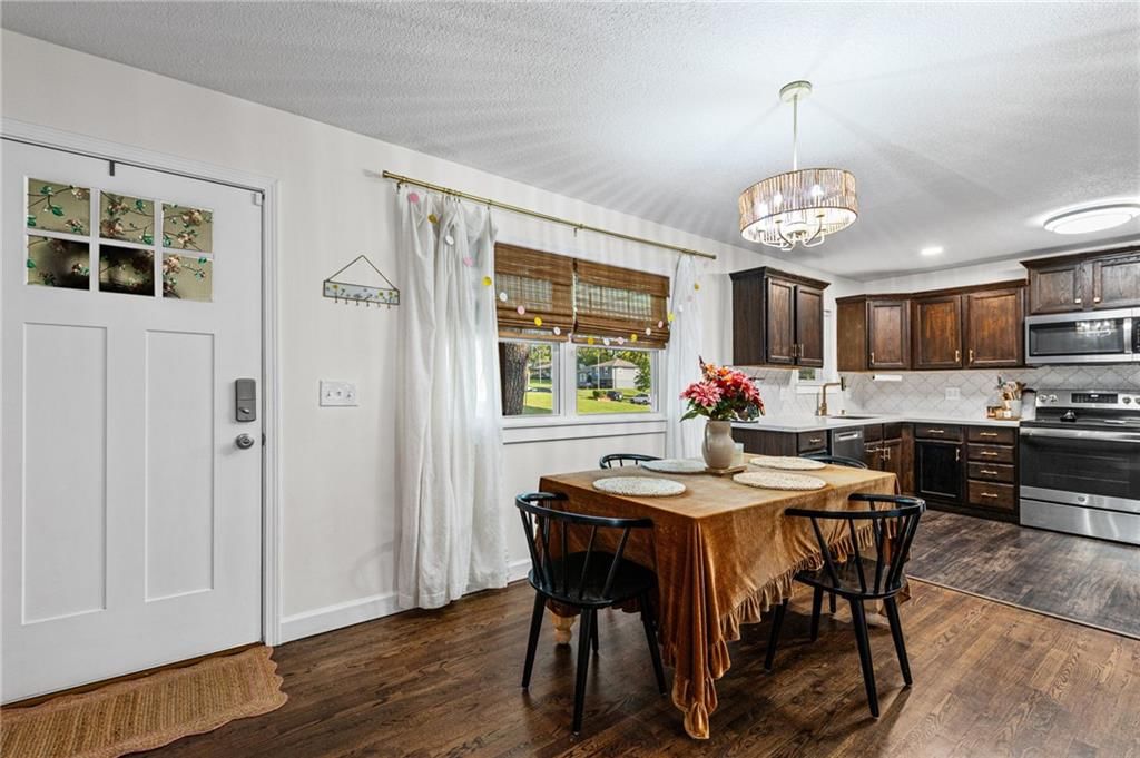 Statement lighting, breakfast nook and white trim at 7711 NE 53rd Terrace, Kansas City, MO 64119