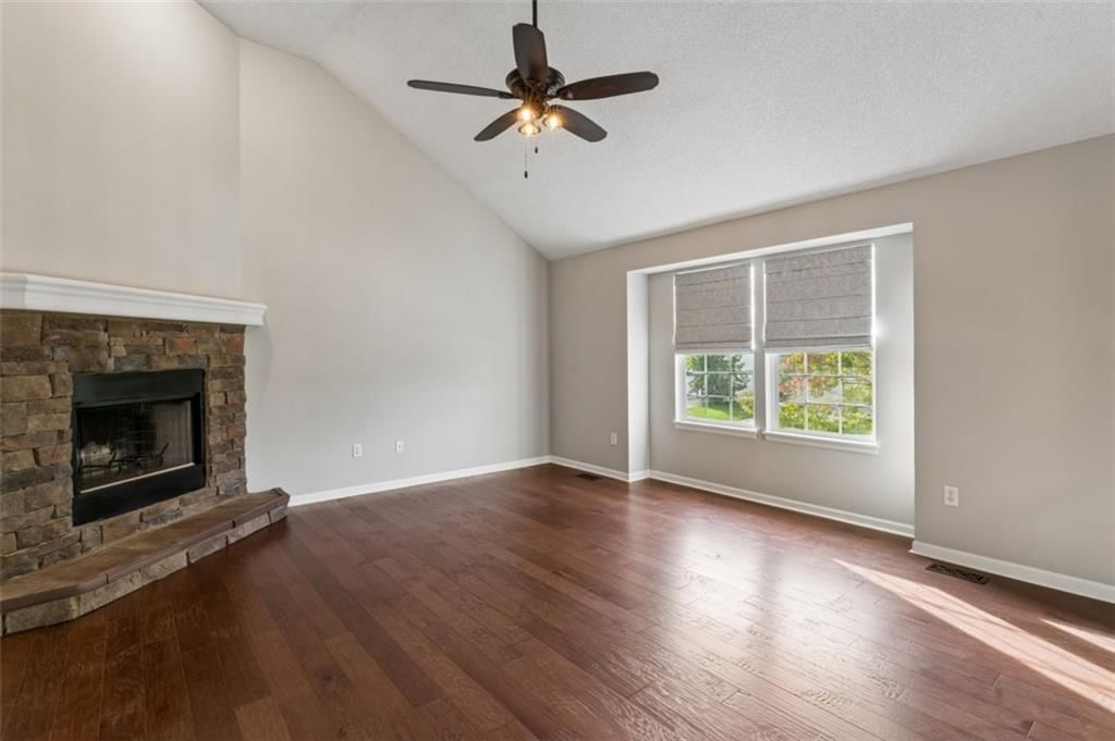 Fireplace, hardwood floors and stone fireplace at 20556 W 220th Terrace, Spring Hill, KS 66083