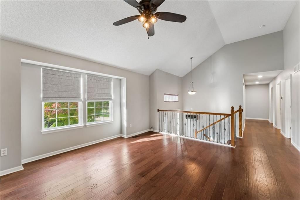Staircase and wood stair railing at 20556 W 220th Terrace, Spring Hill, KS 66083
