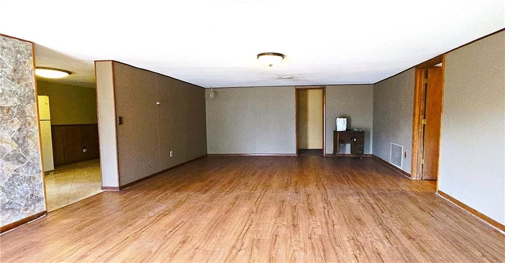Open floor plan and main-floor primary bedroom at 34306 Indianapolis Road, Osawatomie, KS 66064