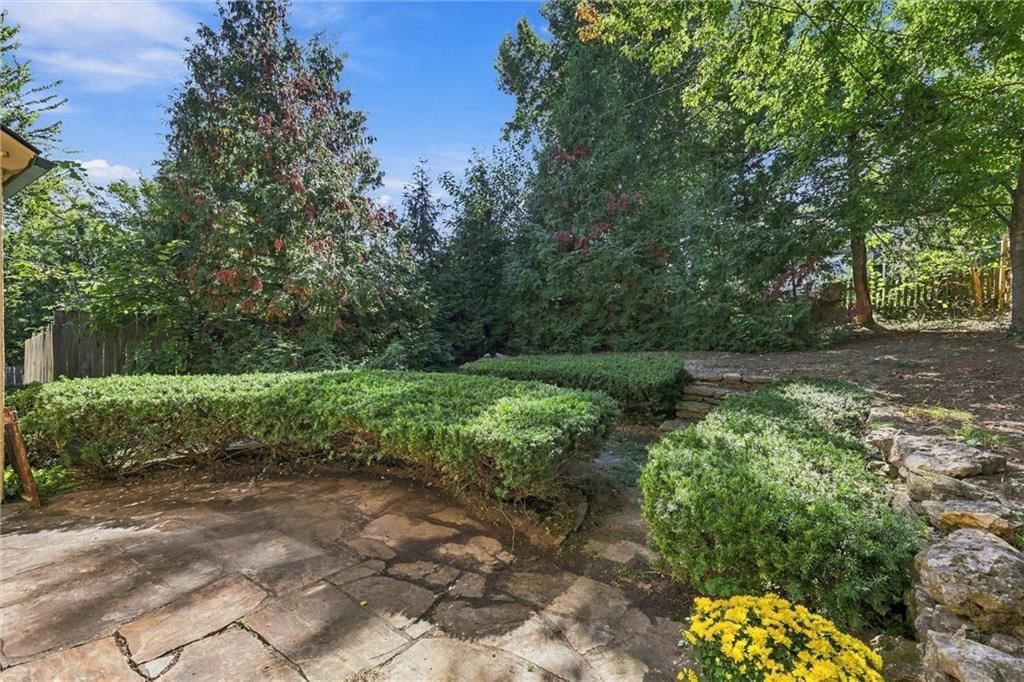 Fenced yard, mature trees and paver patio at 2017 W 50th Street, Westwood Hills, KS 66205