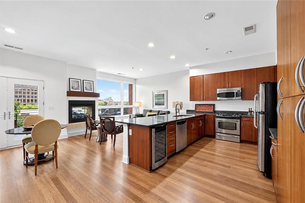 Open floor plan, kitchen island and granite counters at 4521 Wornall Road #106, Kansas City, MO 64111