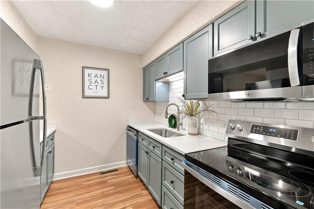 Green kitchen cabinets, shaker cabinets and stainless steel appliances at 1824 E 97th Street, Kansas City, MO 64131