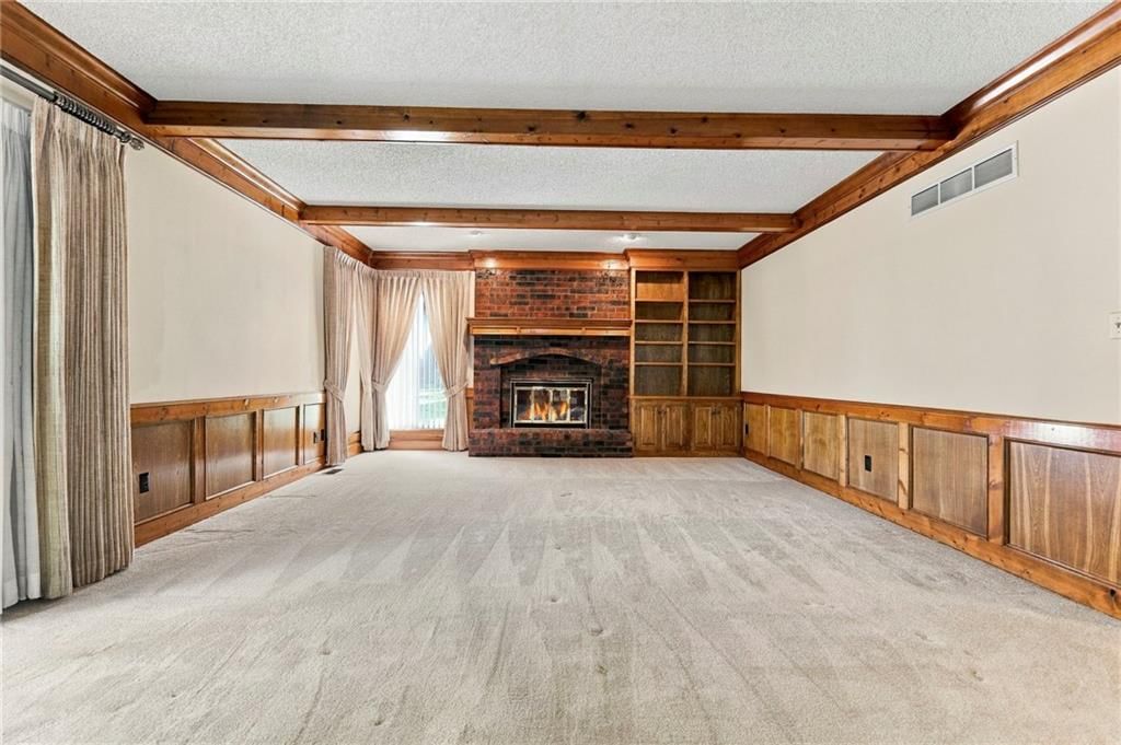 Fireplace and ceiling beams at 1401 Fox Ridge Drive, Blue Springs, MO 64015