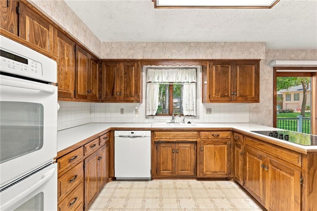 Kitchen island, double oven and electric range at 1401 Fox Ridge Drive, Blue Springs, MO 64015