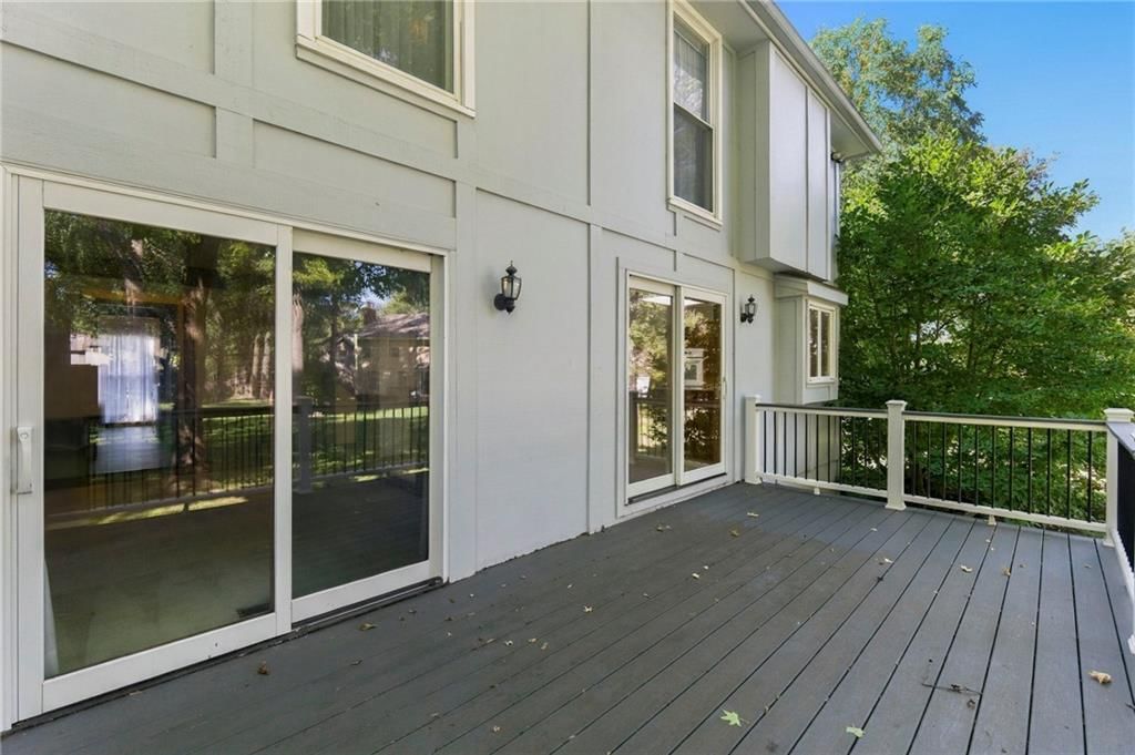 Deck, big backyard and mature trees at 1401 Fox Ridge Drive, Blue Springs, MO 64015