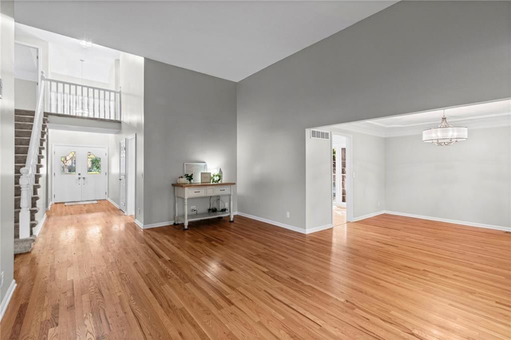 Main-floor primary bedroom and hardwood floors at 11278 Hemlock Street, Overland Park, KS 66210